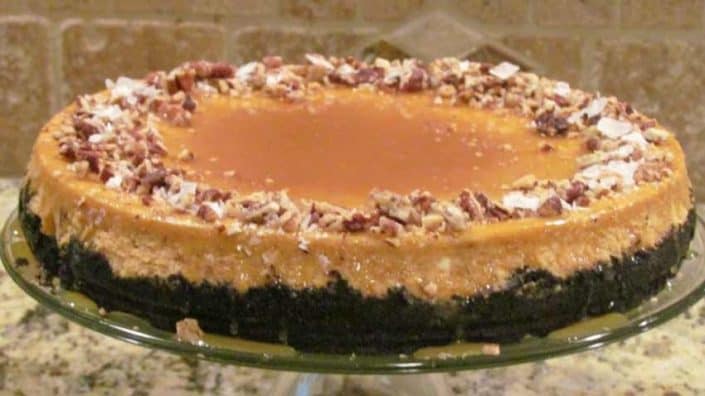 Pumpkin-Orange Cheesecake A close up of a cake on a plate