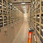 A long hallway with many shelves of books.