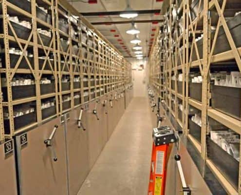 A long hallway with many shelves of books.