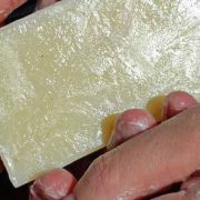 Unscented Handmade Organic Soap A person holding a piece of cheese in their hand.
