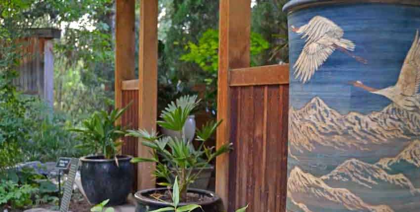 A wooden structure with plants in pots next to it.