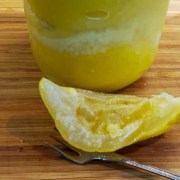 A close up of an orange and a spoon