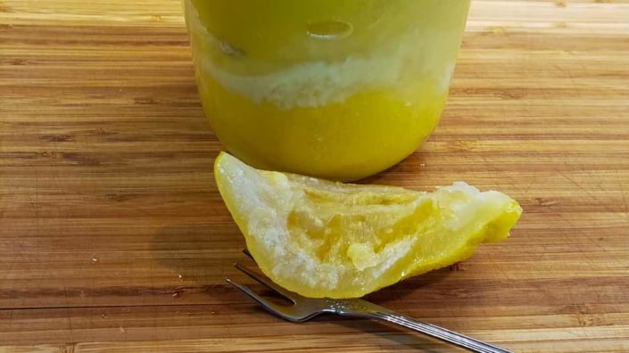 Moroccan Preserved Lemons A close up of an orange and a spoon