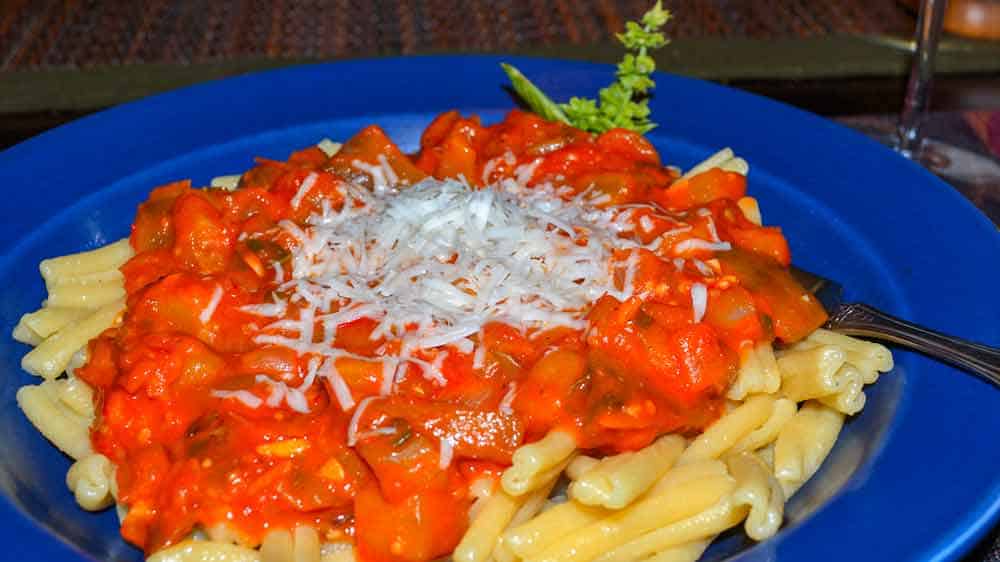Sicilian-Eggplant-and-Tomato-Sauce A plate of pasta with sauce and parmesan cheese.